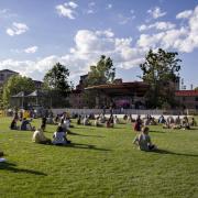 Students sit on Farrand Field lawn to watch a concert