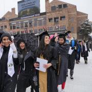 Graduates seated for commencement ceremony at Folsom Field