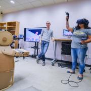 Peter Gyory, left, shows Taylor Salazar how using a low quality prototype to trace in VR can help industrial designers. Photo by Glenn Asakawa.