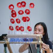 Jennifer Mah prepares her wind loom at the ATLAS Research Showcase. Photo by Glenn Asakawa.