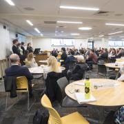 Students present at the Leeds Center Showcase. Photo by Glenn Asakawa.