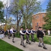 Bagpipers lead the procession from the quad to CU Boulder's 2018 main commencement ceremony at Folsom Field. Photo by Glenn Asakawa.