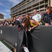 Meghan Bille, advertising, kisses her mom, Bernadette, before the commencement ceremony. Photo by Glenn Asakawa.