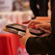 Many companies use technology to allow students to quickly enter their contact information at the Just in Time Career Fair. Photo by Glenn Asakawa.