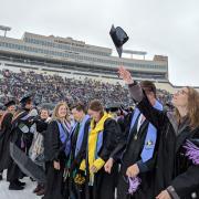 Graduates toss their caps in the air