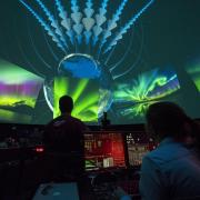 A view from behind the control panel as astrophysical researcher Robert Ergun leads an explanation of the Aurora Borealis. Photo by Glenn Asakawa.