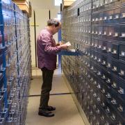 Tim Clark looks through file drawers