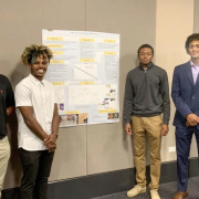 Students posing with a research poster