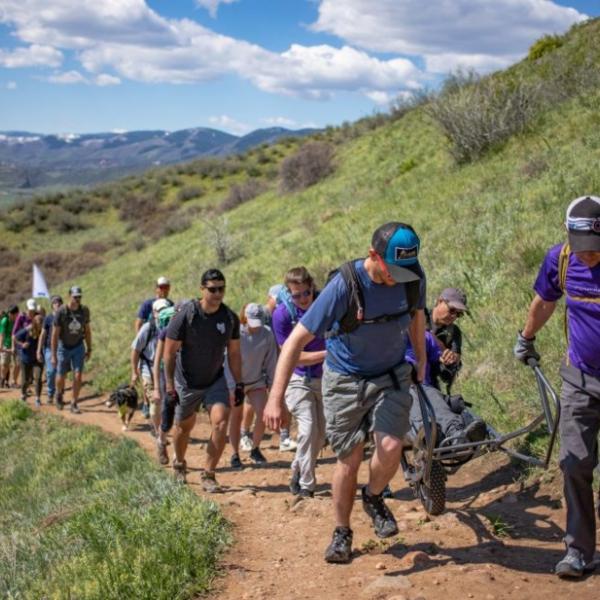 hikers helping a hiker with adaptive hiking 